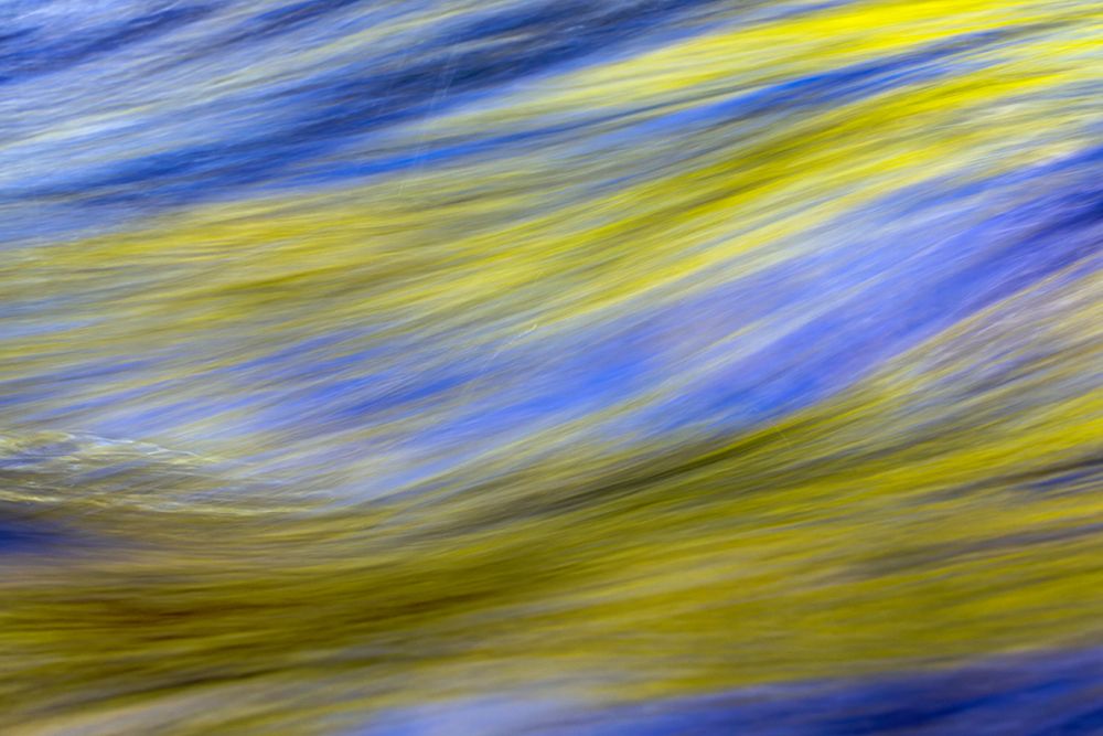 Spring foliage colors and sky reflecting on ripples on stream, Great Smoky Mountains NP, Tennessee